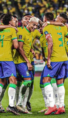 a group of soccer players standing next to each other on top of a green field