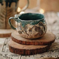 a cup sitting on top of a wooden coaster