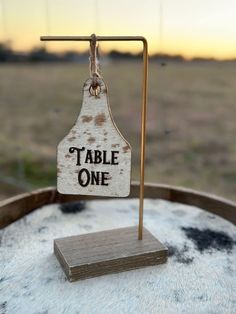 a wooden sign that says table one on it