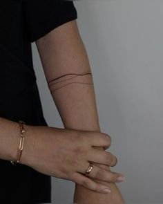 two hands holding each other while wearing gold bracelets