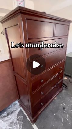 a wooden dresser sitting in the middle of a room