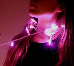 a woman with pink lights around her neck