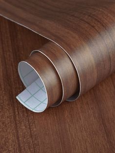 a close up of a wooden surface with some tape on it's end and the edge