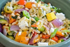 a bowl filled with rice and vegetables on top of a table