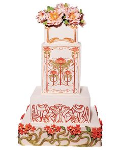 a three tiered cake with flowers on top