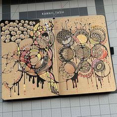 an open notebook with some drawings on it