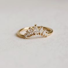 a three stone diamond ring on a white surface