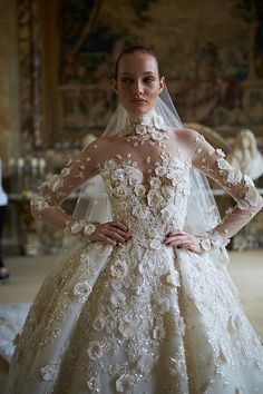 a woman in a wedding dress standing with her hands on her hips