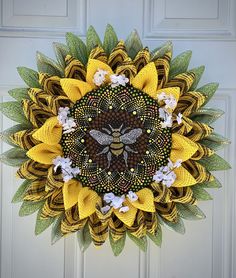 a yellow and green wreath with a bee on it