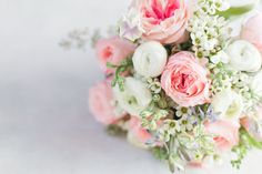 a bridal bouquet with pink and white flowers on the top is photographed against a white background