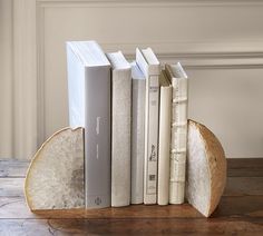 a bookend made out of bread with books on each side and one slice cut in half