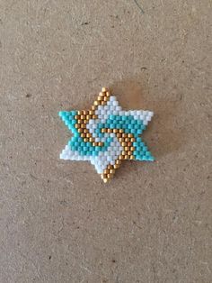 a small beaded star sitting on top of a table