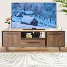 a flat screen tv sitting on top of a wooden cabinet