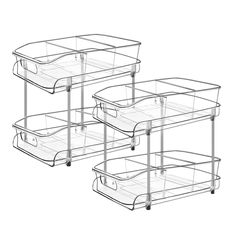 three clear plastic baskets with handles on each side and one holding two empty trays