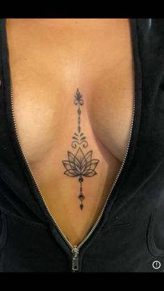 a woman's chest with a tattoo on her left side and an arrow in the middle