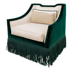 a green chair with fringe trim and pillows