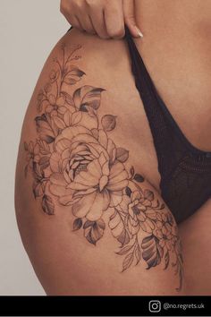 a close up of a woman's stomach with flowers on it and the bottom half of her body