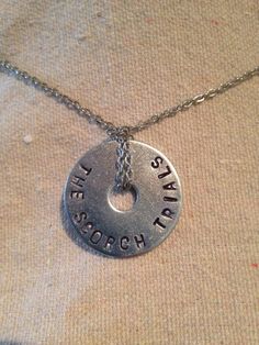 "This necklace is one fender washer with a silver colored chain wrapped around it. The diameter of the washer is 1 1/4 inches. Stamped into the washer is \"The Scorch Trials\", and the letters are colored black. It is fastened by a lobster clasp at the back. You can choose between the three chain lengths of 16\", 18\", and 22\"." Scorch Trials, Maze Runner Trilogy, Maze Runner Cast, Newt Maze Runner, Things I Need To Buy, The Scorch, The Scorch Trials, Maze Runner Series, Gifts For Runners