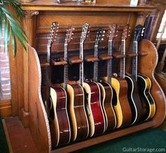 guitars are lined up on display in front of a fireplace