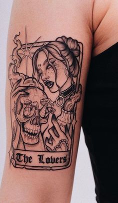 a woman's arm with a tattoo on it that says the lovers and skull