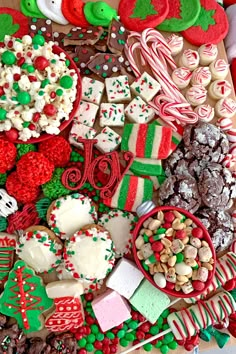 a table topped with lots of different types of cookies and candies on top of each other