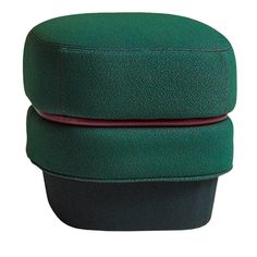 two green and black hats sitting side by side on top of each other in front of a white background