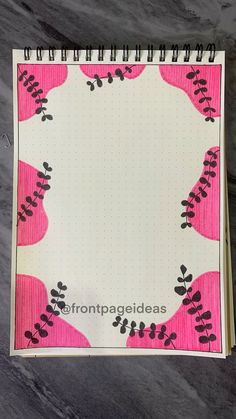 a spiral notebook with pink and black flowers on it