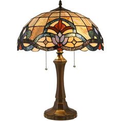 a lamp that is sitting on top of a wooden stand with a stained glass shade