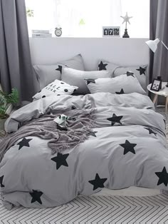 a bed with grey and black stars on it