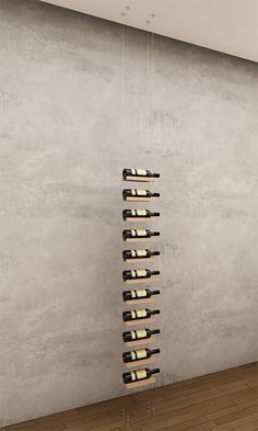 a wine rack in the middle of a room with concrete walls and wooden flooring