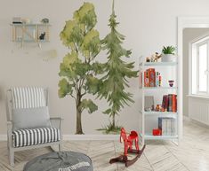 a room with a tree painted on the wall and rocking chair in front of it