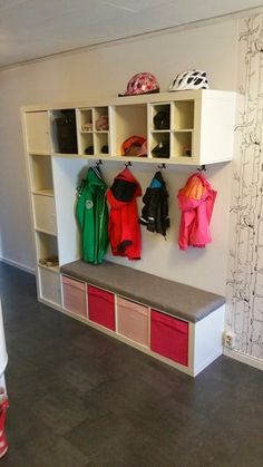 the coat rack is filled with coats and shoes for children to use in their playroom