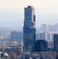 an aerial view of a city with tall buildings and skyscrapers in the background,