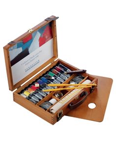 an open wooden box filled with art supplies