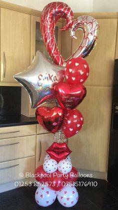 balloons in the shape of hearts and stars are arranged on top of each other,