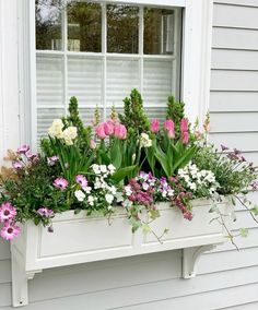 a window box filled with lots of flowers