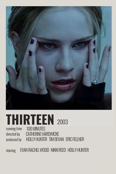 a woman with her hands on her face in front of an advertisement for the film thirteen