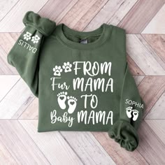 a green sweatshirt with white lettering that says from fur mama to baby mama on it