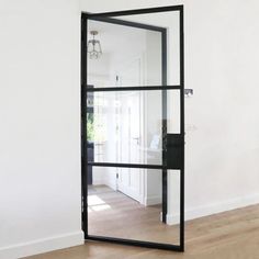 an empty room with a large mirror on the wall and wood flooring in front of it