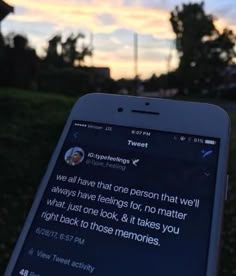 someone is holding up their cell phone to take a photo with the sky in the background