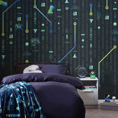 a bed room with a neatly made bed and a wall covered in circuit board decals