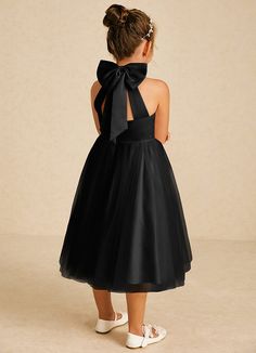 Dora features a charming A-line silhouette in matte satin and tulle, with a stylish halter neckline and playful bows. Sleeveless and easy to wear with a zipper back, it’s perfect for adding a touch of elegance to any special occasion. Sleeveless Tulle Tutu Dress With Bow, Party Dress With Satin Bow And Tulle Material, Elegant Sleeveless Tutu Dress With Bow, Party Dresses With Bow Straps And Tulle Material, Black Dress With Detachable Bow For Party, Sleeveless Tulle Dress With Satin Bow, Black Sleeveless Halter Wedding Dress, Black Sleeveless Halter Dress For Wedding, Sleeveless Black Tutu Dress For Party