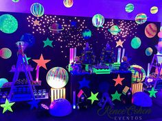 an image of a space themed party with stars and planets on the wall behind it