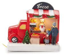 a figurine of a man selling food from a truck