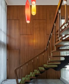 a staircase with two lights hanging from it