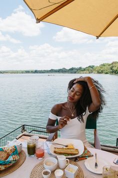 a woman sitting at a table with food on it