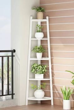 there are many potted plants on the shelf next to the balcony railing and stairs