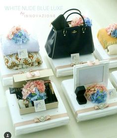 four small boxes with flowers and purses in them