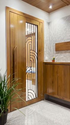 an entry way with wooden doors and plants