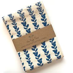 two napkins with blue leaves on them